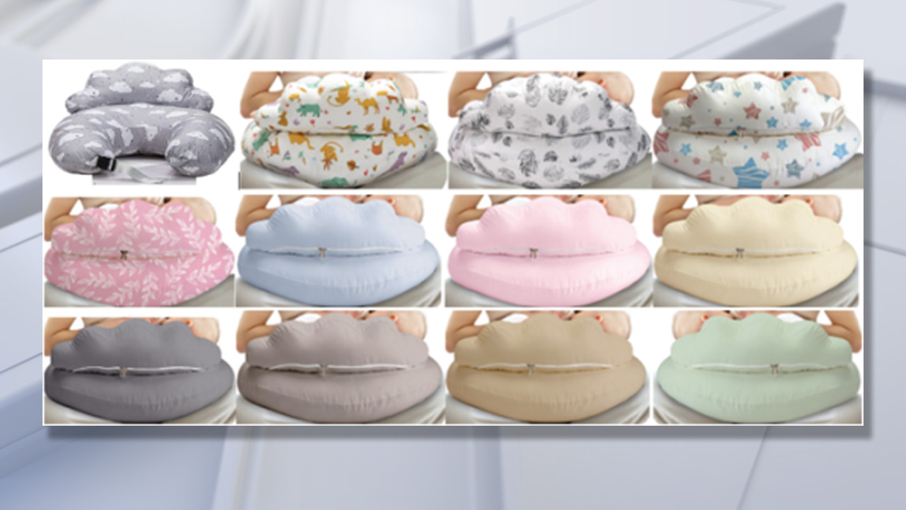 A concerned parent holding a nursing pillow in a nursery setting